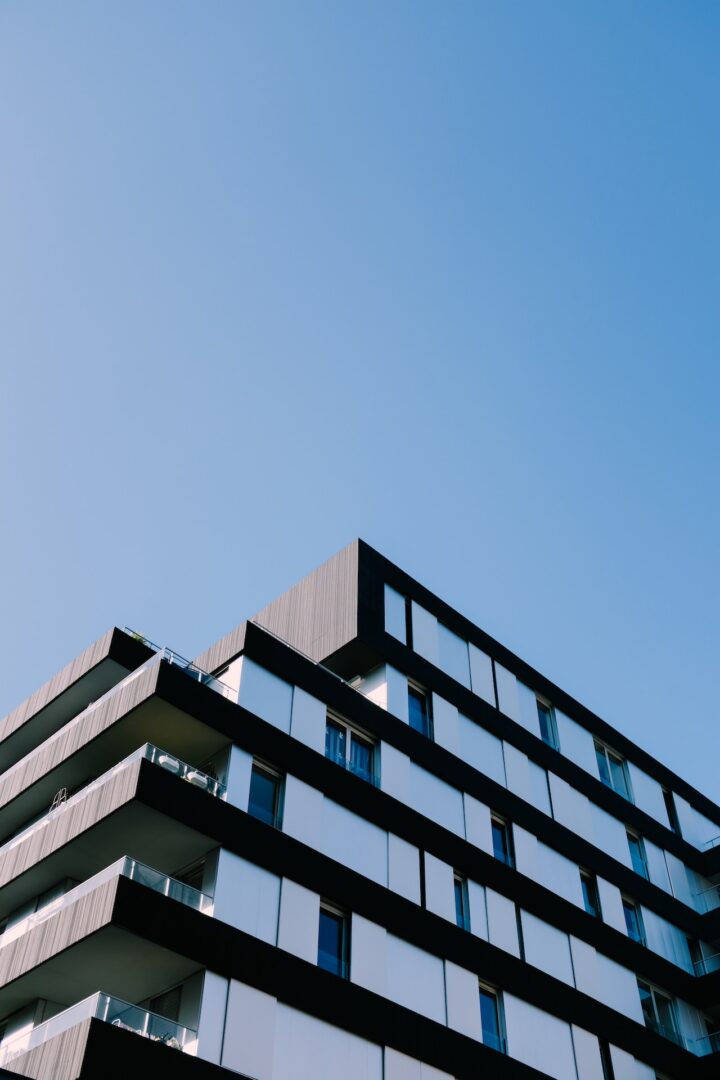 A building with many windows and balconies on the top of it.